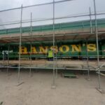 A signwriter is currently putting the finishing touches to the new bridge in the iconic green and yellow brand colours of Hanson's Ale.